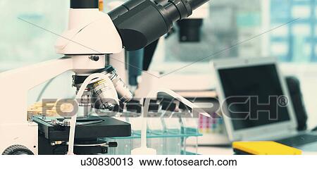 Stock Image - Microscope and scientific equipment in the laboratory.. Fotosearch