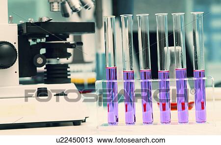 Stock Image - Microscope and test tubes in the laboratory.. Fotosearch