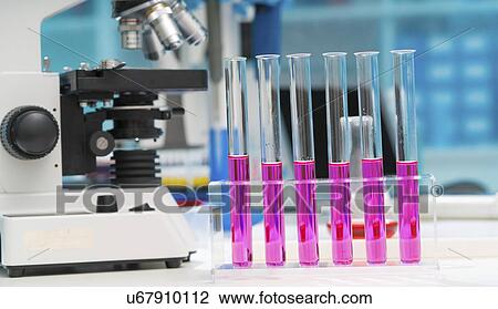 Stock Image - Microscope and test tubes in the laboratory.. Fotosearch