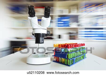 Stock Photo - Microscope and test tubes in the laboratory.. Fotosearch