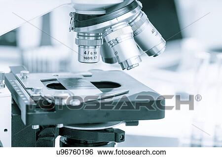 Stock Photograph - Microscope slide on microscope, close up.. Fotosearch