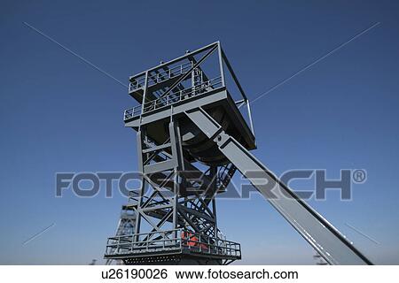 Stock Photograph - Mine shaft lift against clear blue sky.. Fotosearch