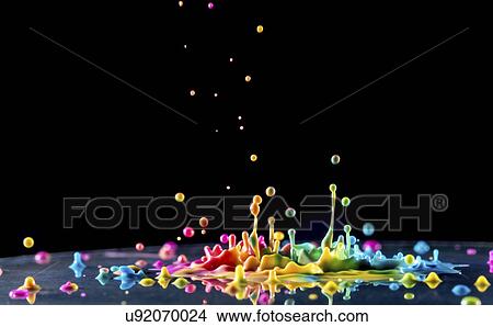 Picture - Multicoloured splashes against a black background,. Fotosearch