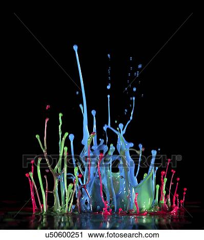 Stock Image - Multicoloured splashes against a black background,. Fotosearch