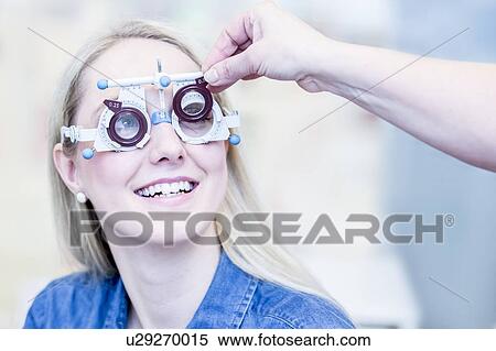Optometrist examining woman's vision View Large Photo Image Stock Photography - Optometrist examining woman's vision. Fotosearch