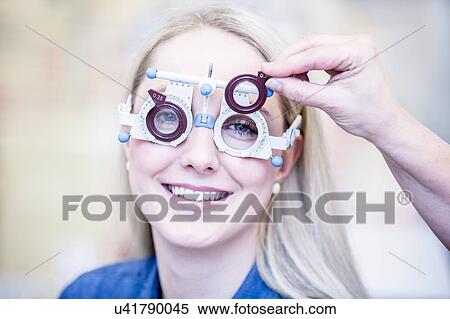 Optometrist examining woman's vision View Large Photo Image Stock Photography - Optometrist examining woman's vision. Fotosearch