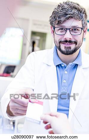 Optometrist handing receipt to woman View Large Photo Image Stock Photo - Optometrist handing receipt to woman. Fotosearch