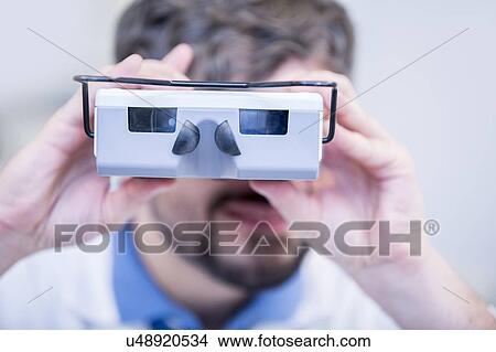 Picture - Optometrist performing eye test. Fotosearch