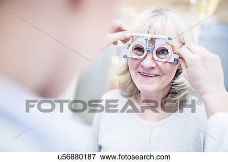 Stock Photo - Optometrist performing eye test. Fotosearch