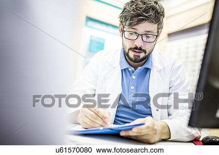 Optometrist writing prescription View Large Photo Image Stock Image - Optometrist writing prescription. Fotosearch