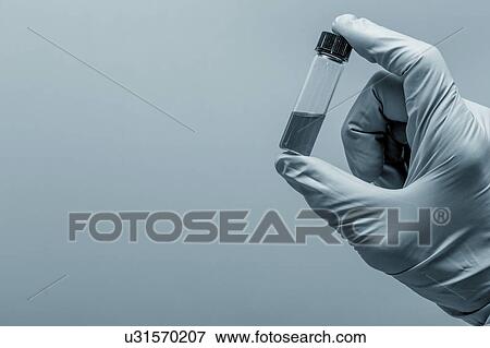 Person holding vial, studio shot. View Large Photo Image Stock Photo - Person holding vial, studio shot.. Fotosearch