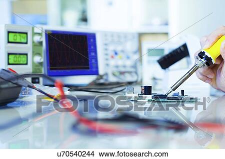 Picture - Person working in an electronics laboratory.. Fotosearch