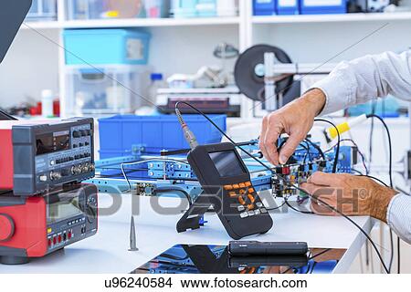 Person working in electronics laboratory. View Large Photo Image Picture - Person working in electronics laboratory.. Fotosearch