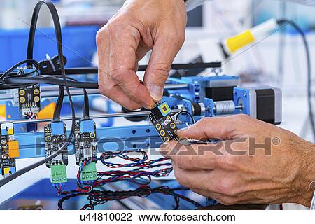 Stock Image - Person working in electronics laboratory.. Fotosearch