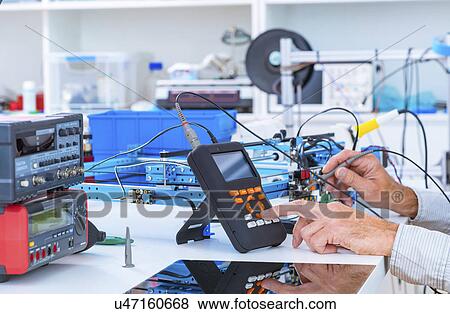 Person working in electronics laboratory. View Large Photo Image Stock Photo - Person working in electronics laboratory.. Fotosearch