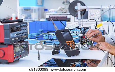 Stock Photo - Person working in electronics laboratory.. Fotosearch