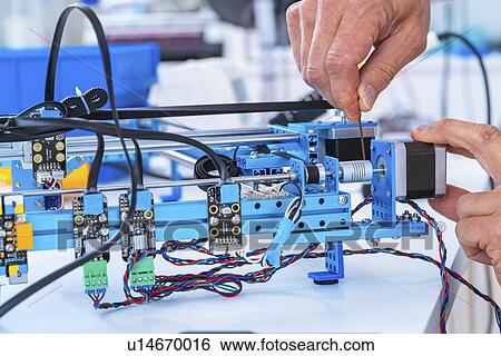 Stock Photograph - Person working in electronics laboratory.. Fotosearch