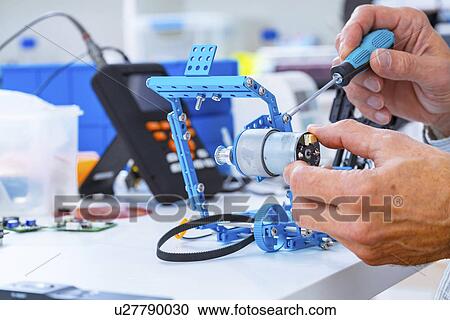 Person working with robotic parts. View Large Photo Image Stock Image - Person working with robotic parts.. Fotosearch