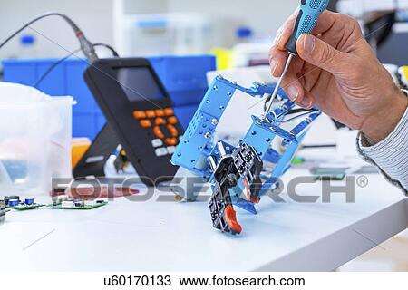 Person working with robotic parts. View Large Photo Image Stock Image - Person working with robotic parts.. Fotosearch