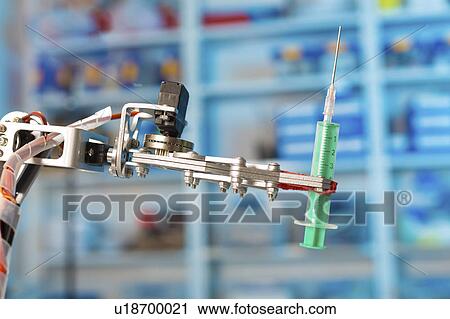 Stock Image - Robotic arm holding syringe in the laboratory.. Fotosearch