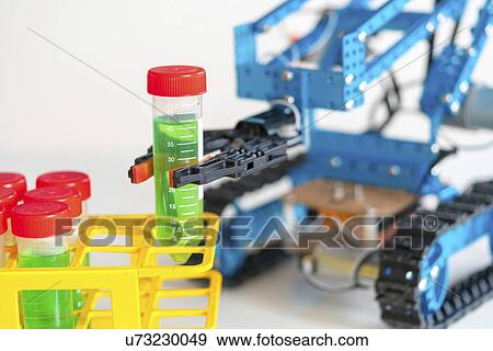 Stock Photo - Robotic arm holding test tube on caterpillar tracks.. Fotosearch