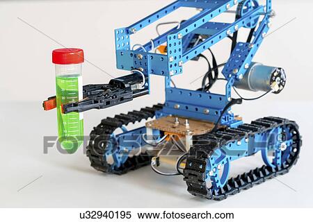 Stock Photography - Robotic arm holding test tube on caterpillar tracks.. Fotosearch