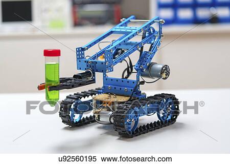 Stock Photography - Robotic arm holding test tube on caterpillar tracks.. Fotosearch