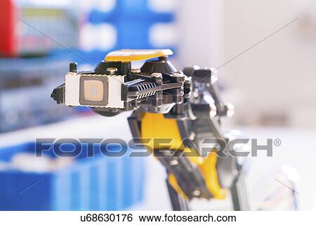 Stock Photograph - Robotic arm with microchip.. Fotosearch