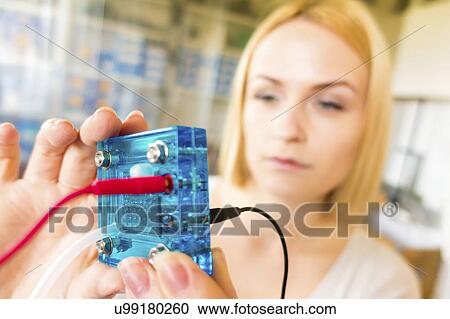 Scientist holding hydrogen fuel cell View Large Photo Image Stock Image - Scientist holding hydrogen fuel cell. Fotosearch