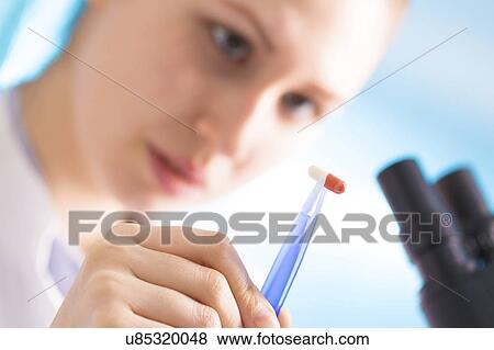 Scientist holding pill in tweezers View Large Photo Image Stock Photo - Scientist holding pill in tweezers. Fotosearch