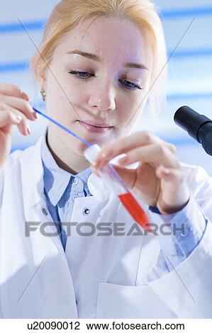 Stock Image - Scientist holding test tube. Fotosearch