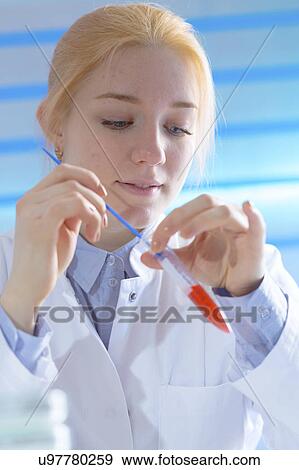 Scientist holding test tube View Large Photo Image Stock Photo - Scientist holding test tube. Fotosearch