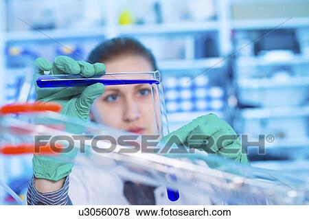 Scientist pouring liquid into test tube View Large Photo Image Stock Photo - Scientist pouring liquid into test tube. Fotosearch