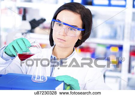 Scientist pouring sample into beaker View Large Photo Image Stock Photo - Scientist pouring sample into beaker. Fotosearch