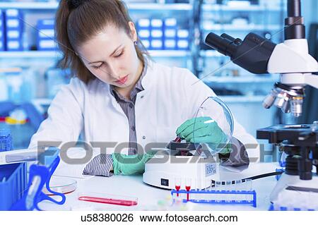 Scientist using a centrifuge View Large Photo Image Stock Photograph - Scientist using a centrifuge. Fotosearch