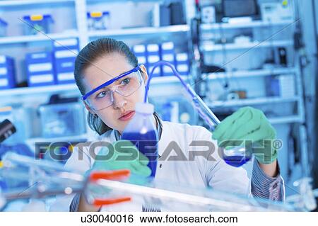 Stock Photograph - Scientist using laboratory equipment. Fotosearch