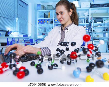 Stock Photo - Scientist using laptop in the laboratory. Fotosearch