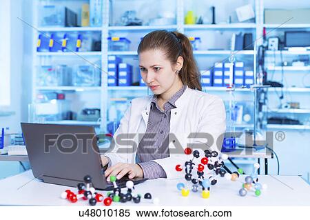Stock Photography - Scientist using laptop in the laboratory. Fotosearch