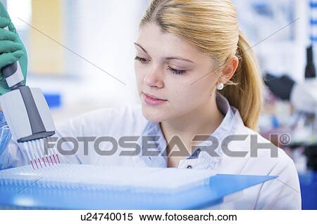 Stock Photography - Scientist using multi pipette. Fotosearch