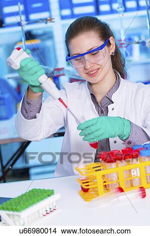 Picture - Scientist using pipette. Fotosearch