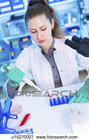 Stock Photo - Scientist using pipette. Fotosearch