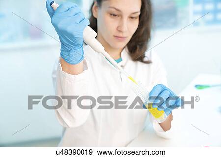 Stock Photo - Scientist using pipette. Fotosearch
