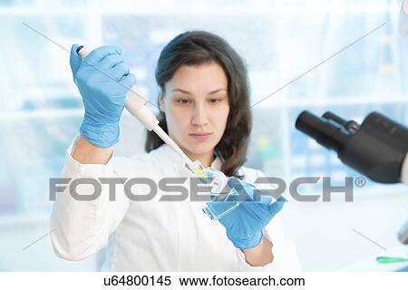 Scientist using pipette View Large Photo Image Stock Photography - Scientist using pipette. Fotosearch
