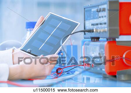 Stock Photography - Scientist with solar fuel cell in laboratory.. Fotosearch