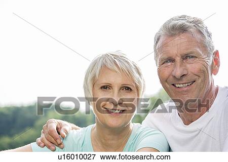 Senior couple smiling towards camera View Large Photo Image Stock Photo - Senior couple smiling towards camera. Fotosearch