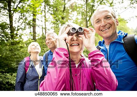 Senior woman looking through binoculars View Large Photo Image Stock Photography - Senior woman looking through binoculars. Fotosearch