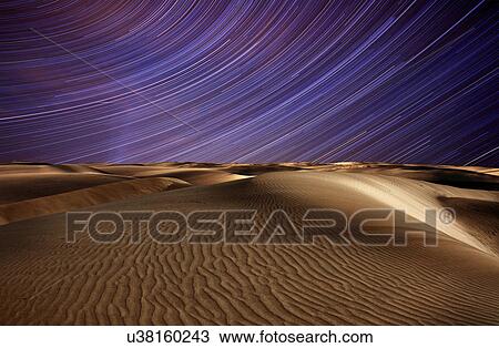 Star trails in the sky above the desert. View Large Photo Image Stock Image - Star trails in the sky above the desert.. Fotosearch
