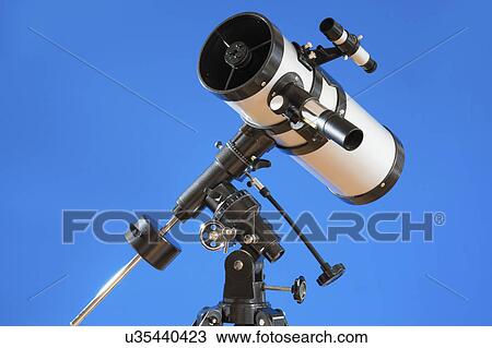 Stock Image - Telescope against blue background.. Fotosearch