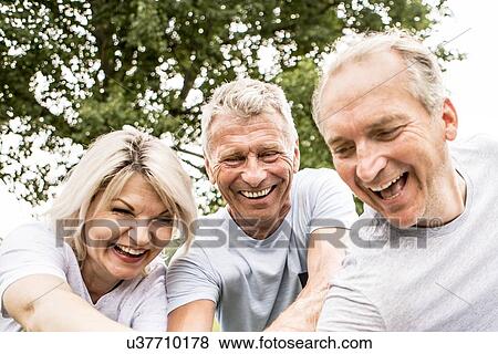 Three people smiling, candid portrait View Large Photo Image Stock Photo - Three people smiling, candid portrait. Fotosearch