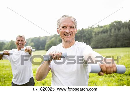 Two men exercising with hand weights View Large Photo Image Stock Photography - Two men exercising with hand weights. Fotosearch